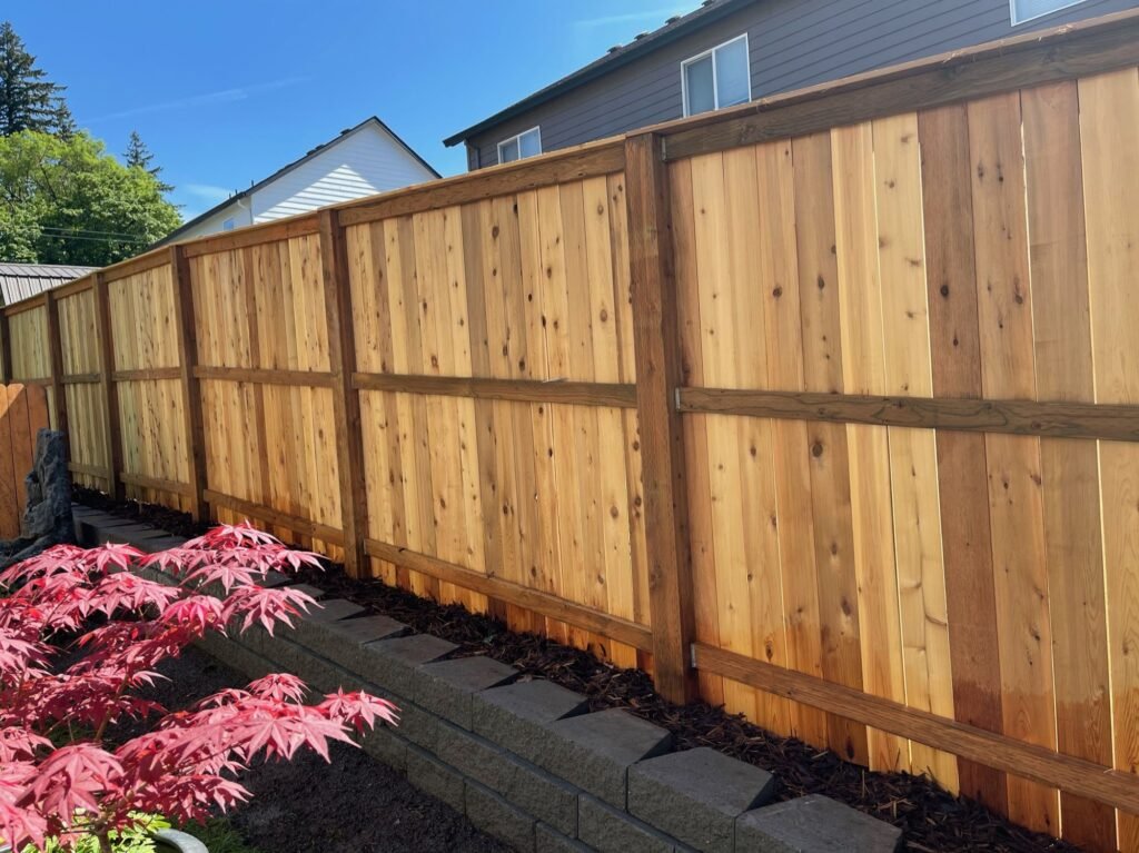 Cedar fence retaining wall by Rose City Redevelopment in Gresham, OR